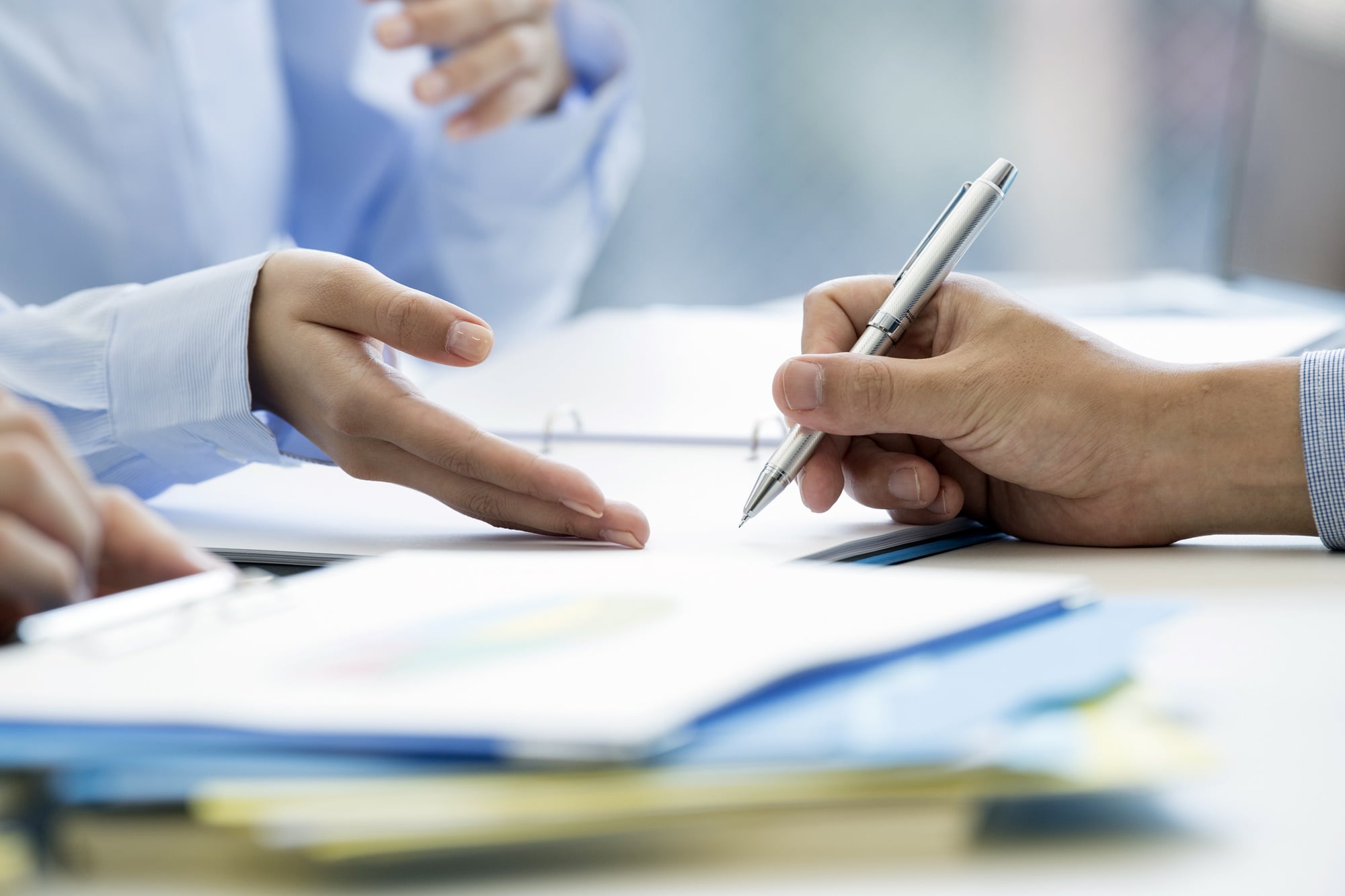 A man is signing a contract