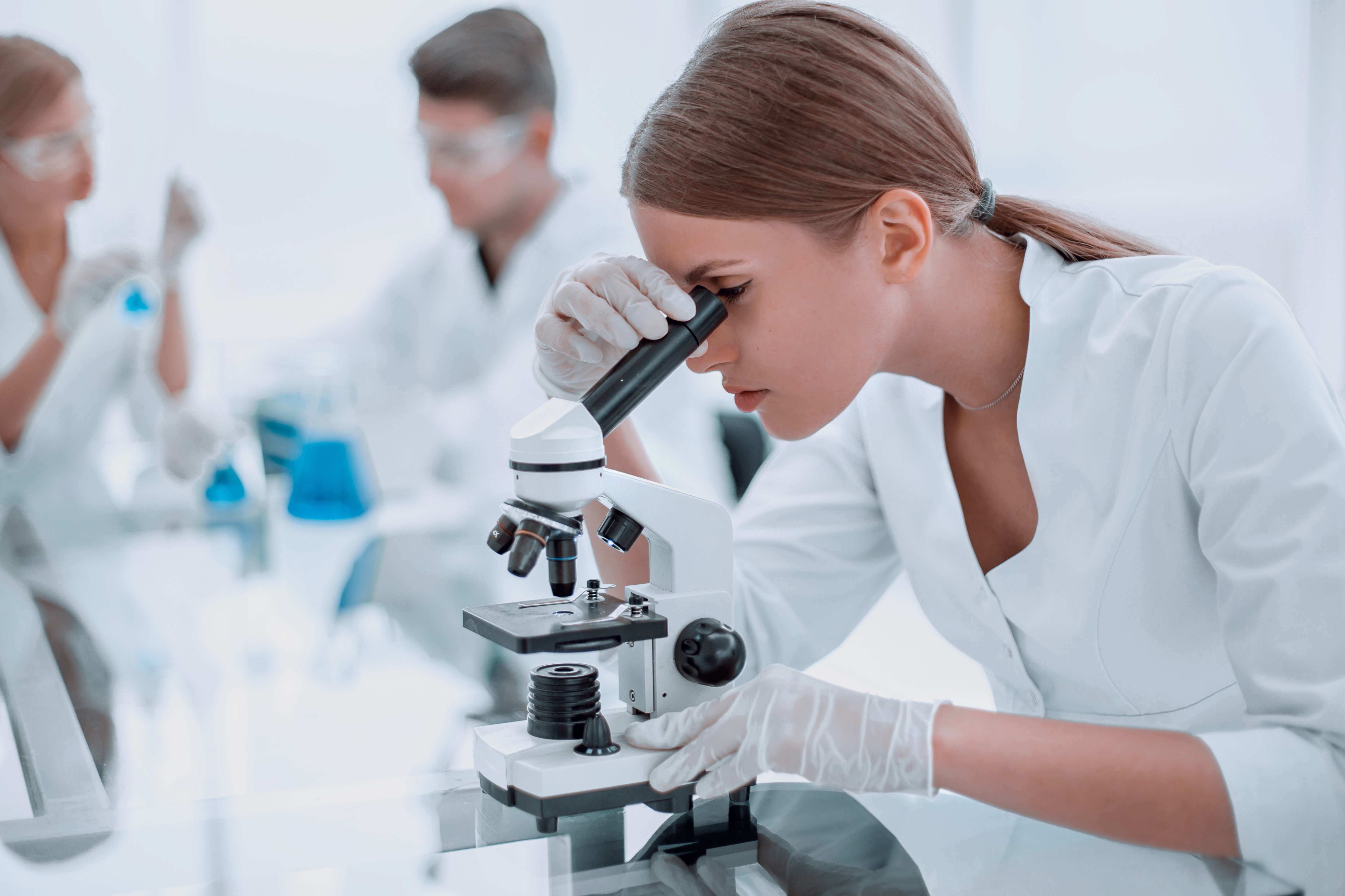 female scientist using a microscope in a chemical laboratory